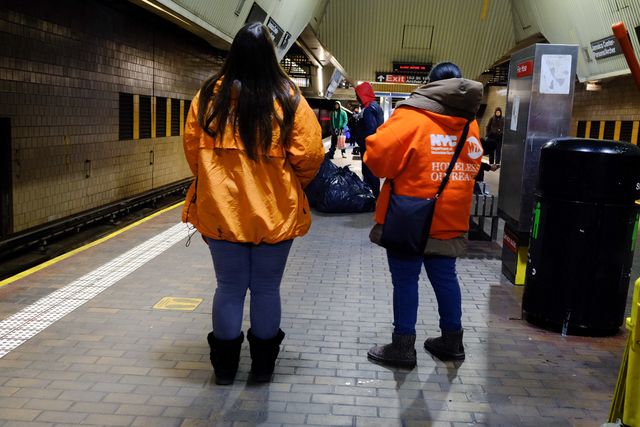 Outreach workers with the Bowery Residents’ Committee wait on a subway platform in Jamaica, Queens.